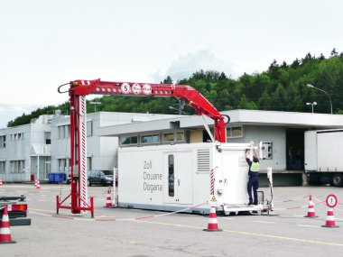 A customs house officer is setting up the x ray check device