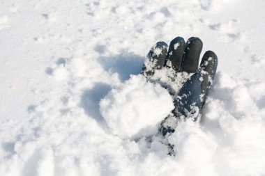 Glove buried in snow after avalanche clipart