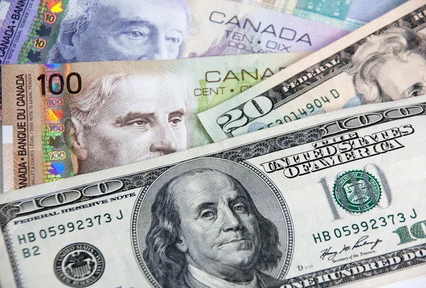 Canadian dollars vs. US dollars — Stock Photo, Image