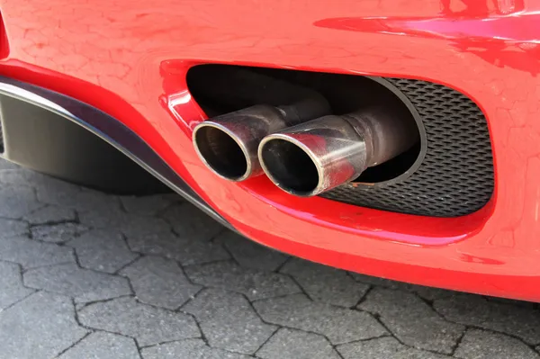 Tubo de emisión de un coche rojo — Foto de Stock