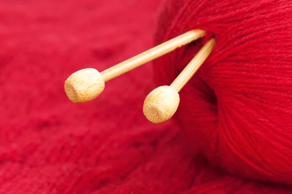 Knitting needle a red woolen yarn