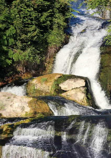 Waterfall down to the rocks and into the river — Stock Photo, Image