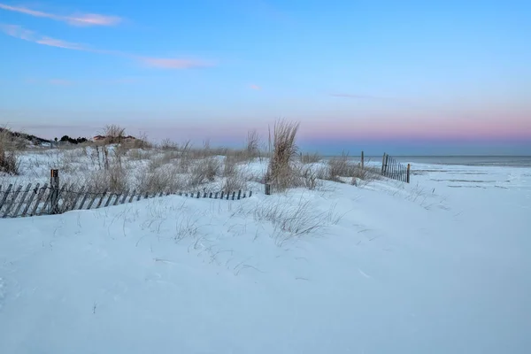 Snow drifts at dusk on the beach in Long Branch New Jersey.