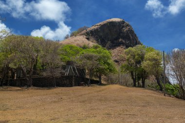 A mountain overlooks the historic Fort Rodney on Pigeon Island in Saint Lucia.