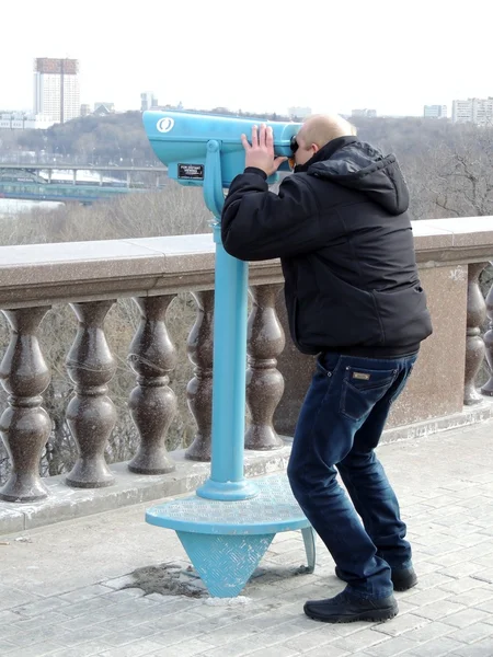 Un homme qui regarde à travers les jumelles — Photo