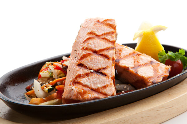 Grilled Foods - Salmon Steak with Vegetables. Garnished with Lemon and Parsley