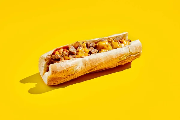 Chiken cheesesteak in minimal style. American fast food in yellow background with shadow. Philly steak sandwich trendy concept. Junk food in colour background