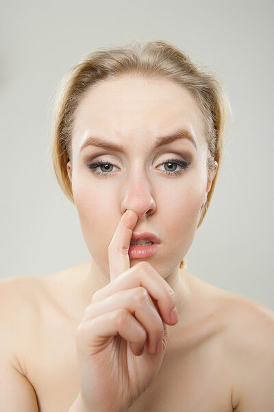 funny portrait of young bored woman picking nose, dorky silly fun