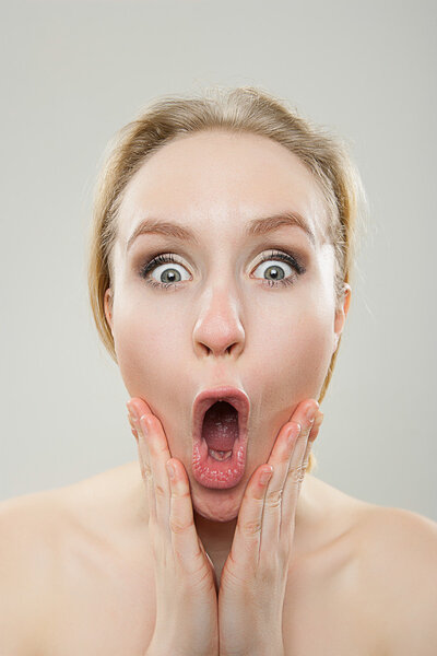 funny portrait of young woman looking surprised, dorky silly fun