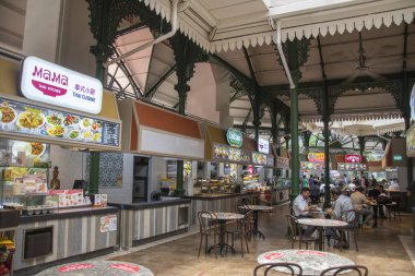 Singapur - 11 Ekim 2021 Lau Pa Sat Gıda Mahkemesi 'nde yemek yiyen insanlar. Lau Pa Sat Singapur şehir merkezinde bulunan tarihi bir binadır..