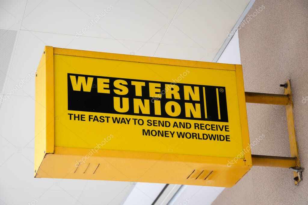 Kuala Lumpur, Malaysia- Apr 17, 2022: Western Union sign text and brand logo on office facade. It is an American multinational financial services company.