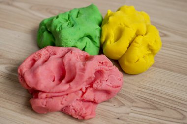 3 pieces of play dough . Lithuanian flag colors, independence day theme