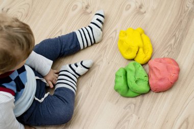 Child plays with play dough. Lithuanian flag colors, independence day theme