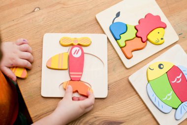 Jigsaw Bebek Erken Eğitim Oyuncakları 3 boyutlu Yapboz Çocuklar Yetenek Egzersizi Çocuklar Tahta Hediyeler. Erkek eli yapboz parçasında. Erken eğitim, odaklanma egzersizleri