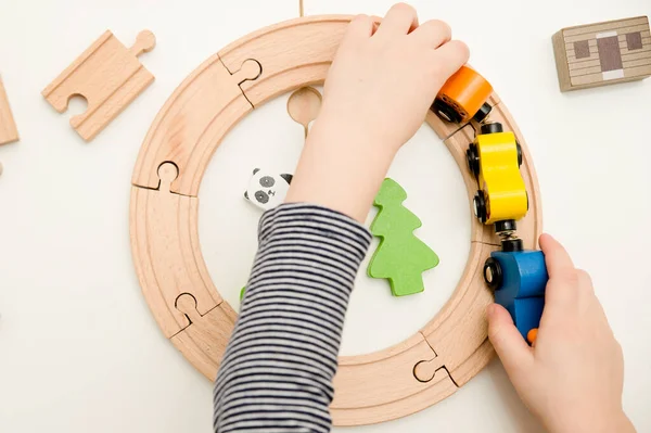 Boy Plays Wooden Toys Railway Train Animal Wagons Wooden Floor — Stockfoto