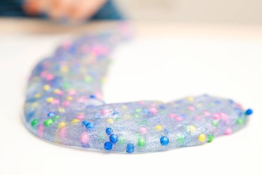 İki renkli mavi ve pembe balçık. Mukus ezilmiş, gerilmiş, yırtılmış ve eller tarafından sıkılmış. arkaplan için soyut görünüm.