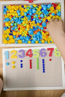 İğne yerleştiren numaracı çocuk sayesinde. Evde oyna. Çocukların iyi motor becerileri geliştirmesi için uygulama, oyun yoluyla mantıklı düşünme. Saymayı öğren ve hayal gücünü, yaratıcılığı canlandır..