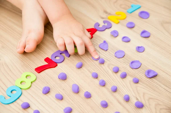 Play-Doh stones and numbers. Counting DIY game. Mathematical task. Play at home. Way of learning.