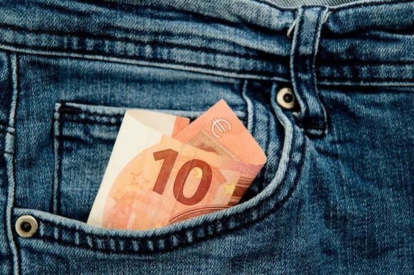 Money in my jeans pocket, euros in the back pocket of blue jeans. Concept of wealth and wellbeing. Spending cash in the supermarket, unplanned purchases.