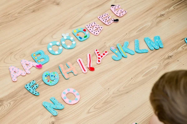 Full of sensory alphabet in capital letters made from stuffed felt. Toy and implement for preschool and primary school kids learning to read. To educate children with special needs. Montessori colors.
