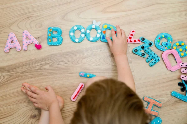 Full of sensory alphabet in capital letters made from stuffed felt. Toy and implement for preschool and primary school kids learning to read. To educate children with special needs. Montessori colors.