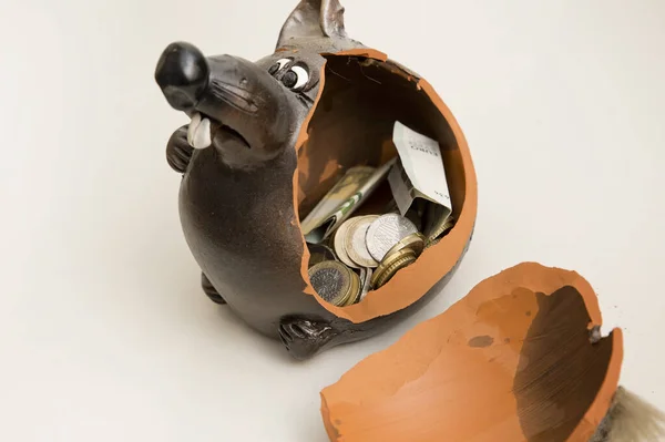 Broken piggy bank with money on white background. Saving savings at home. Finance, saving, investing. Money management at home. The concept of financial business.