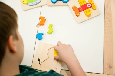 Jigsaw Bebek Erken Eğitim Oyuncakları 3 boyutlu Yapboz Çocuklar Yetenek Egzersizi Çocuklar Tahta Hediyeler. Erkek eli yapboz parçasında. Erken eğitim, odaklanma egzersizleri