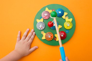 Let's go fishing. Wooden fishes and fishing rod with magnet on the tip. Early education, counting game, fine motor skills.