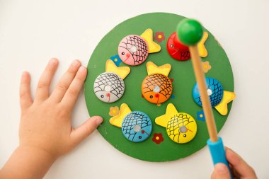 Let's go fishing. Wooden fishes and fishing rod with magnet on the tip. Early education, counting game, fine motor skills.