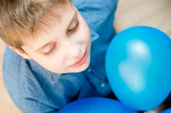 Global autism day commemoration theme. Boy with a blue balloon.