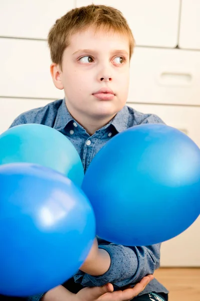 Global autism day commemoration theme. Boy with a blue balloon.