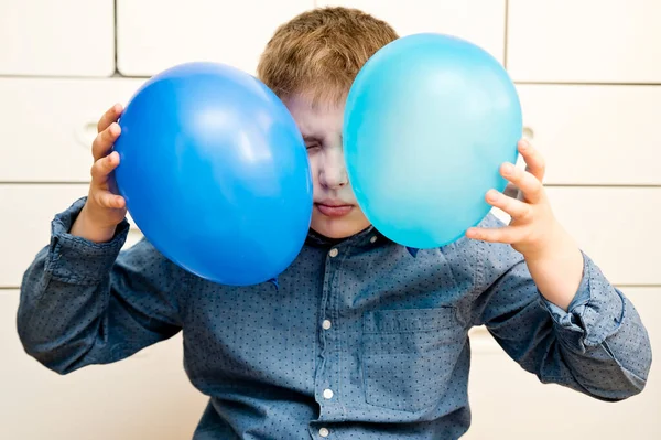 Global autism day commemoration theme. Boy with a blue balloon.