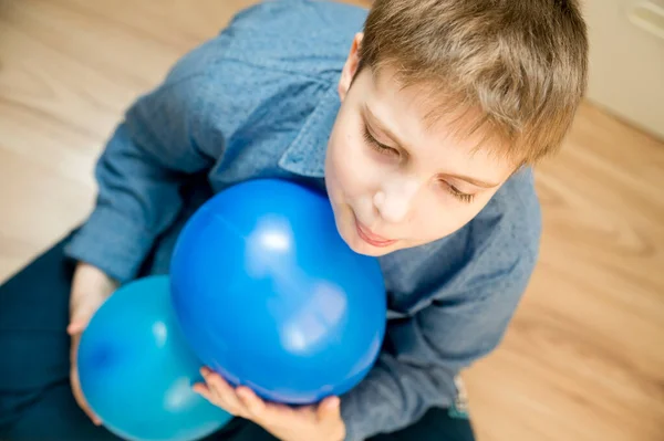 Global autism day commemoration theme. Boy with a blue balloon.