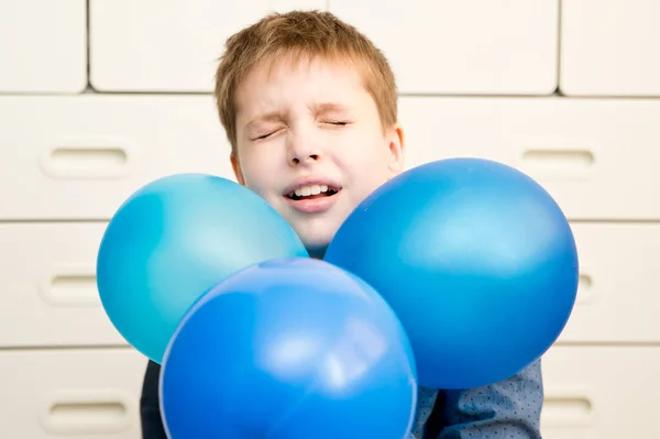 Global autism day commemoration theme. Boy with a blue balloon.