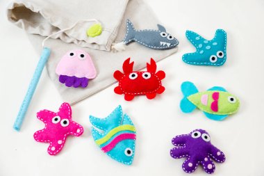 Hand made stuffed felt toy. Fishing rod with magnet and fishes or other sea animals. Different colors. Safe eco stuffed toy for infants and toddlers. Early education implement.