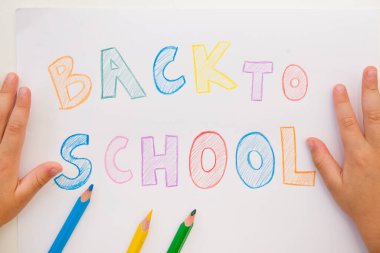 I don't want to go back to school. On white A4 paper sheet written words with different color pencils. Summer ending and new study year beginning.