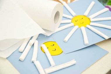 Paper work. The sun made from kitchen towel rolls glued on colored carton and painted with gouache. Activities at home. creative ideas for preschool or kindergarten teachers.