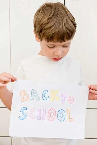 I don\'t want to go back to school. On white A4 paper sheet written words with different color pencils. Summer ending and new study year beginning.