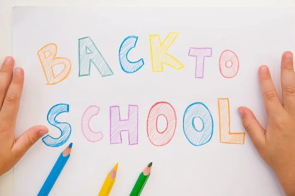 I don\'t want to go back to school. On white A4 paper sheet written words with different color pencils. Summer ending and new study year beginning.