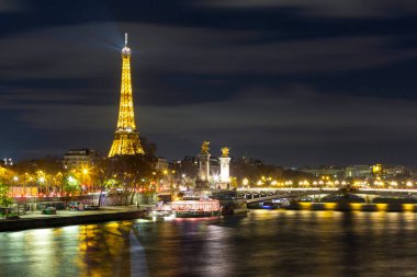 Paris, France - Nov, 28 - 2021: Statue at the Alexander III Bridge with the Eiffel Tower in the background, Paris, France