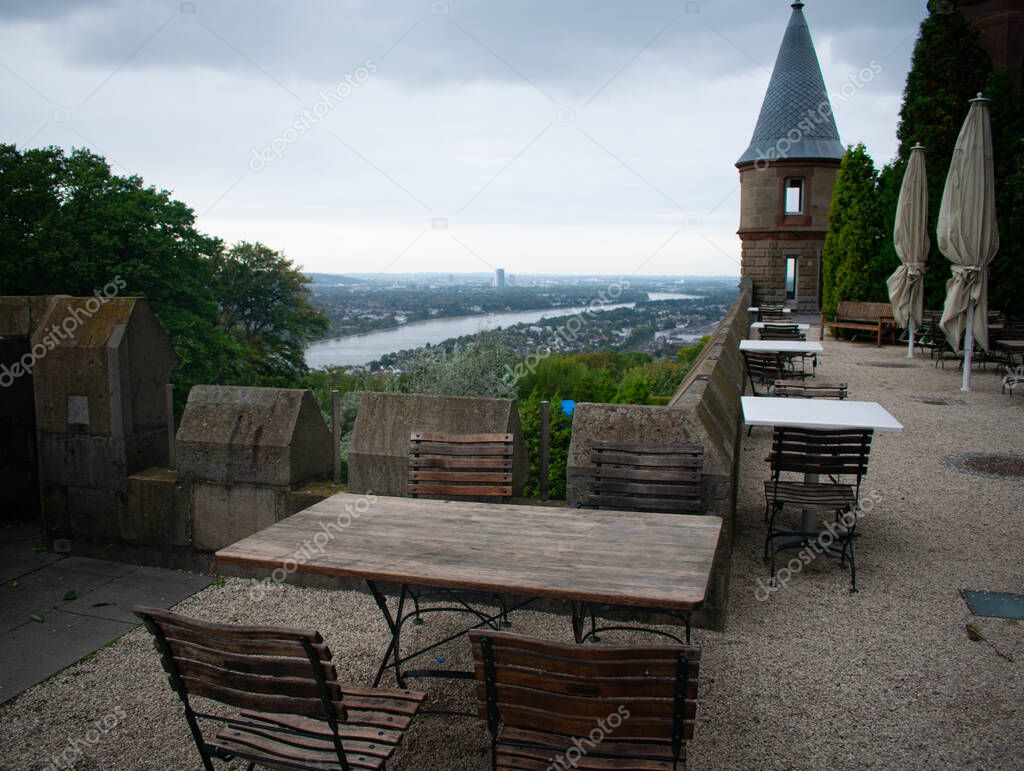 Drachenburg Castle in Bonn, Germany with downtown city and shipping canal in the background