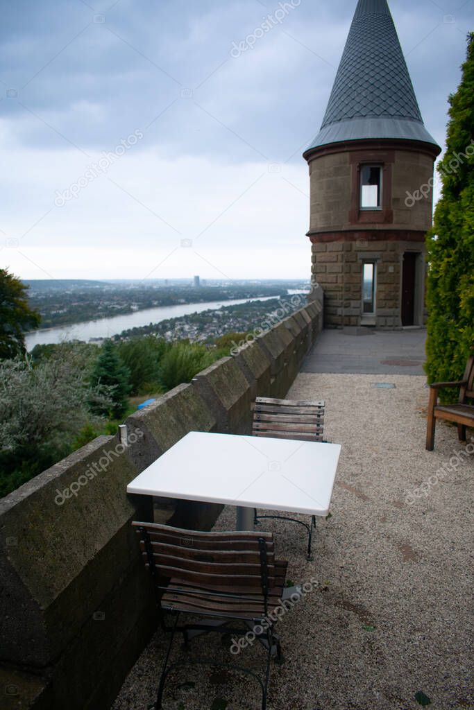 Drachenburg Castle in Bonn, Germany with downtown city and shipping canal in the background