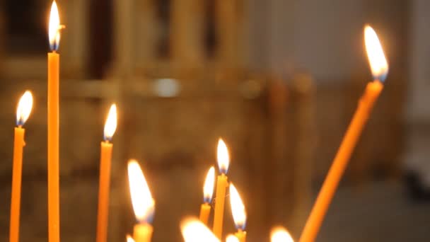 Église orthodoxe russe. Brûler des bougies sur un chandelier — Video