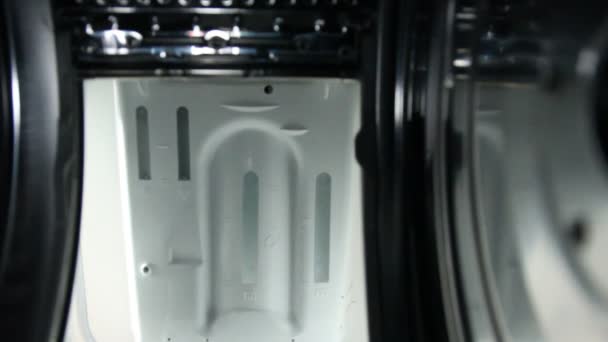 Мужчина загружает грязное белье в стиральную машину (вертикальный тип ) — стоковое видео