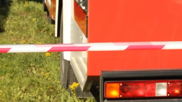 Warning tape fencing against fire engine — Stock Video