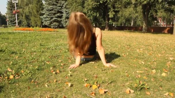 Μια νεαρή κοπέλα σε ένα πάρκο. καλοκαίρι — Αρχείο Βίντεο