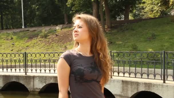 Een jong meisje in een park. zomer — Stockvideo