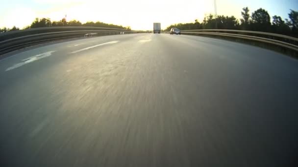 Evening highway. The camera on the level of asphalt — Stock Video