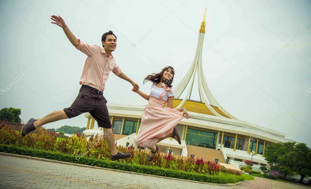Lovely couple jump up together1