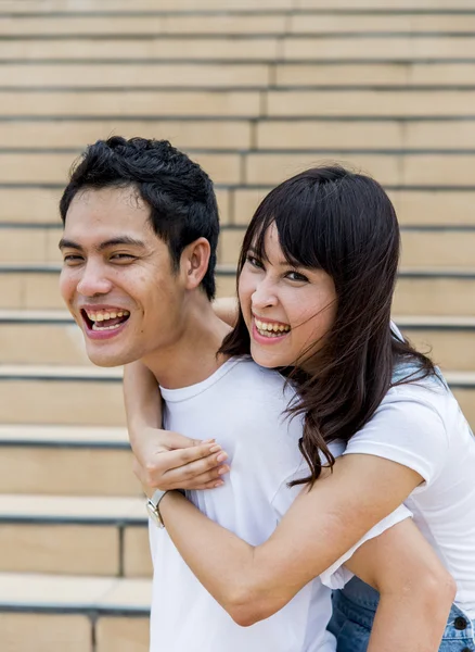 Lovely couple piggy back ride on the stairs2 — Stock Photo, Image